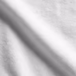 Close-up of the white cotton single jersey of the plain t-shirts, showing the fine knit loops and smooth yarn texture