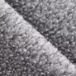 Close-up of grey marl brushed fleece showing the dense looped pile and the heathered fibre mix across a soft diagonal fold
