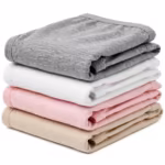 Folded stack of ladies cotton briefs in grey marl, white, soft pink and beige, showing the matte single jersey and covered elastic waistbands