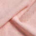 Close-up of the soft pink cotton-modal single jersey of the maternity t-shirts, showing the fine knit loops and smooth yarn texture