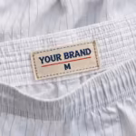 Close-up of the boxer shorts inside back waistband with woven YOUR BRAND label and waistband stitching