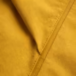 Close-up of the yellow matte coated woven shell fabric of the casual rain jacket, weave showing under the coating