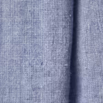 Close-up of light indigo chambray plain weave with indigo warp threads over white weft and natural cotton fibres