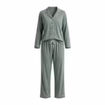 Ladies sage green two-piece pyjama set in cotton single jersey, full front view of the matched pair: a button-front top with a notched collar, white piping on the collar, placket and cuffs, matte buttons and a chest pocket, worn with long pants with an elastic waistband, a white drawcord and piped hems