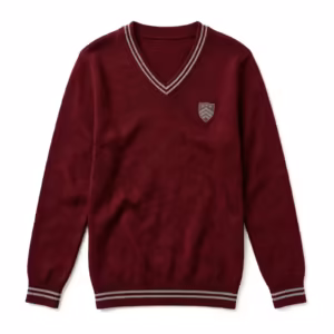 Knitted school sweater in burgundy with a V-neck band carrying two light grey stripes, an embroidered shield crest on the chest and striped ribbed cuffs and hem, full front view